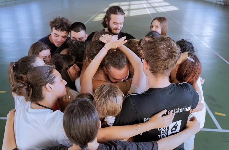 Workshop group in a close huddle