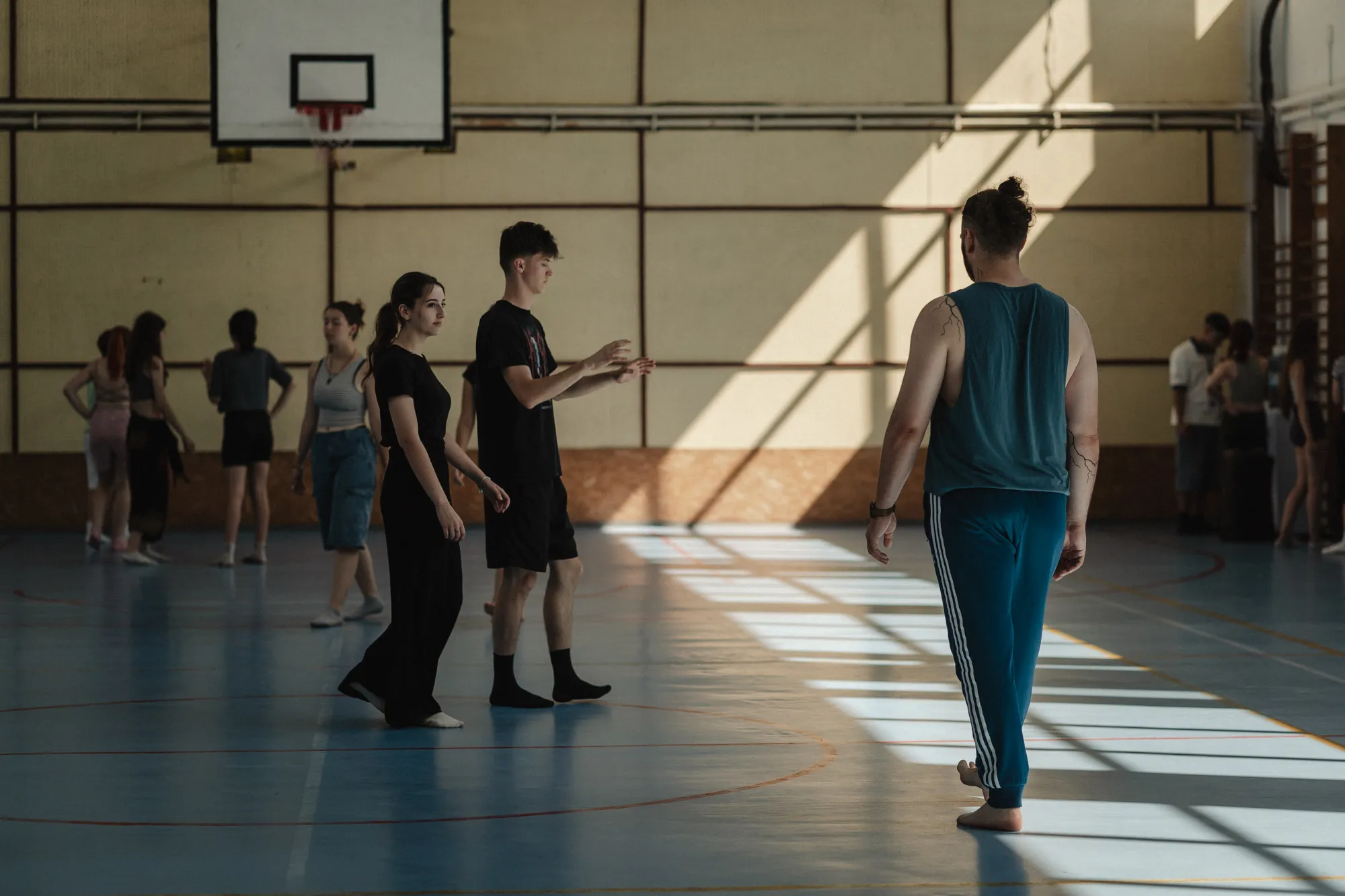 Participants practising in a sunlit sports hall